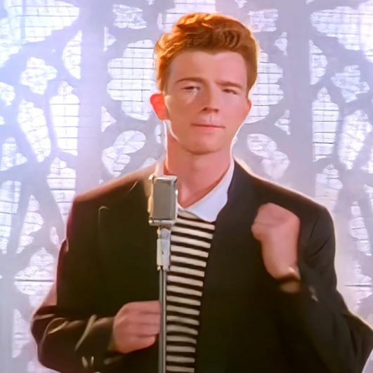 Rick Astley is on fine form as he takes to the stage in a pink suit for